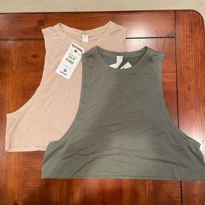 NWT muscle tanks.